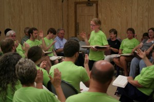 A camper leading at the evening singing