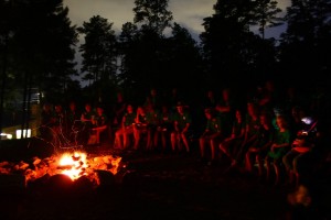 Campers gather around the campfire in the evening at Youth Camp, 2013.